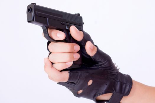 close up of female hand holding a gun