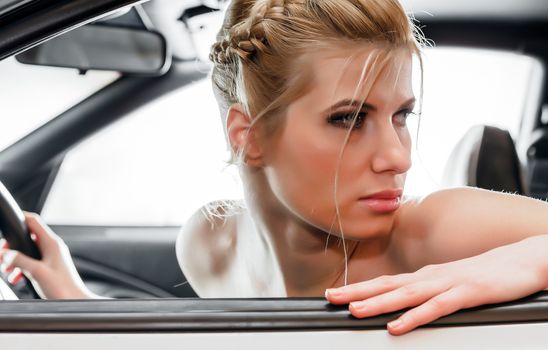 Young Woman Sat In The Drivers Seat of Her Car