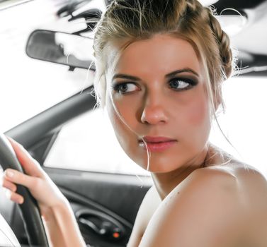 Young Woman Sat In The Drivers Seat of Her Car