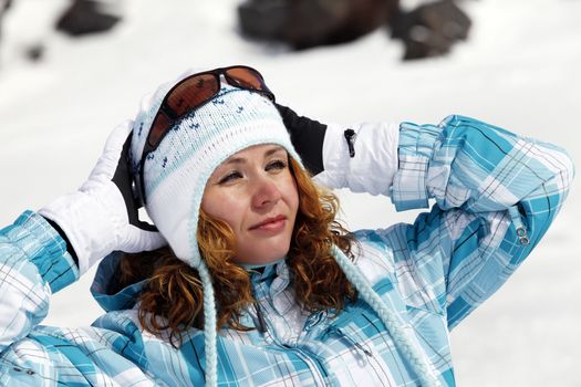 The happy girl in a blue ski suit