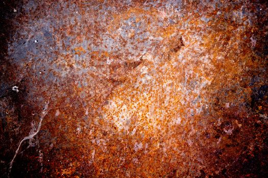 Grungy old rusting metal surfaceGrungy old rusting metal surface with pitted flaking blue paint and red ferric oxides or corroded rust caused by moisture and weathering, background texture