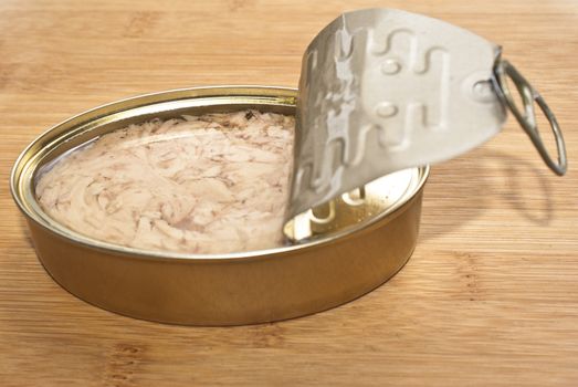 Can of Tuna isolated on a wooden kitchen bench