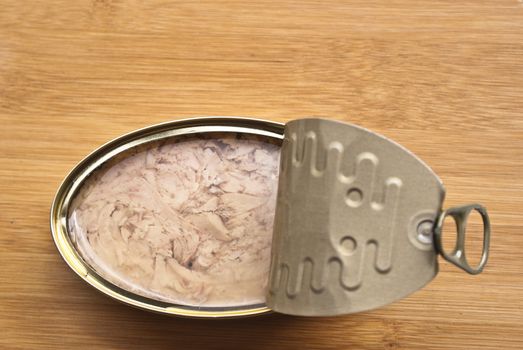 Can of Tuna isolated on a wooden kitchen bench