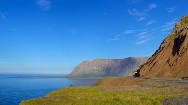 Iceland summer landscape. Fjord, house, mountains. Panorama.