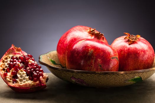 fresh and ripe pomegranate on the decorative plate