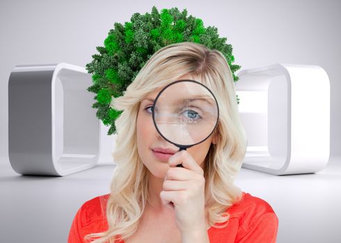 Composite image of fair-haired woman looking through a magnifying glass