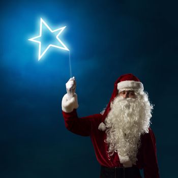 Santa Claus holding a shining light symbol of the star for thread