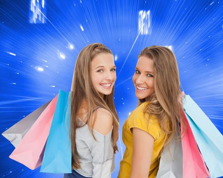 Composite image of two young women with shopping bags 