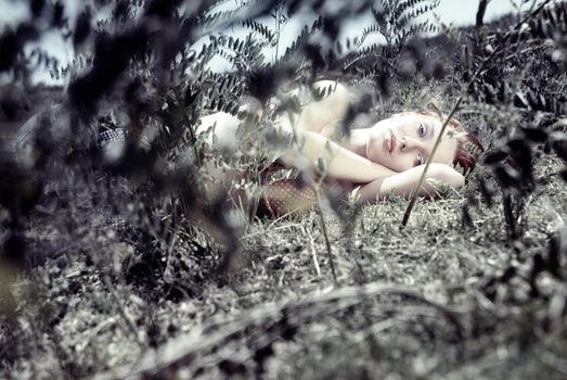 Photo of the resting beautiful lady laying in the grass