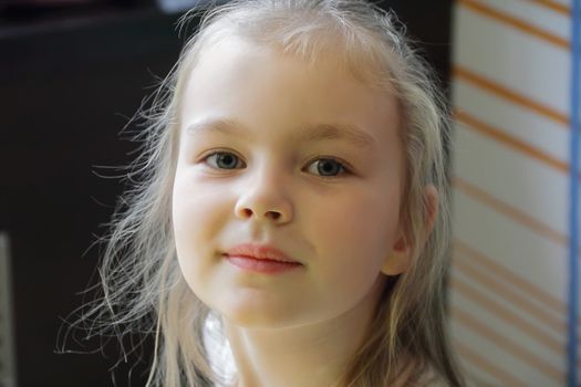 Portrait of beautiful girl with blond hair and blue eyes