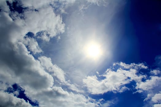 Image of the Sun and fluffy blue sky