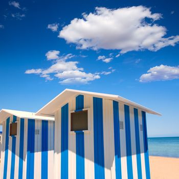 Beach houses in Alicante Denia blue and white stripes at Mediterranean sea of Spain