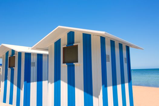 Beach houses in Alicante Denia blue and white stripes at Mediterranean sea of Spain