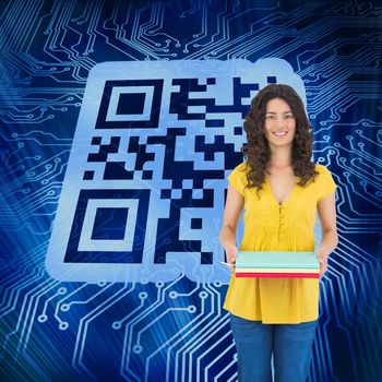 Composite image of smiling curly haired brunette holding notebooks