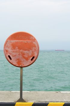 life bouy stand infront of the sea