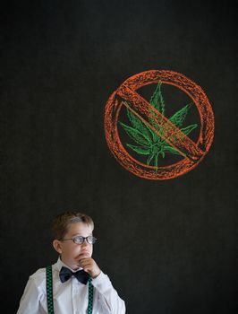 Thinking boy dressed up as business man with no weed marijuana on blackboard background