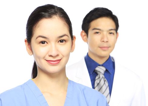 A woman and a man in medical attire. Shallow depth of field.