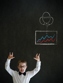 Knowledge rocks boy dressed up as business man with chalk success graph and balloon on blackboard background