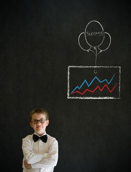 Thinking boy dressed up as business man with chalk success graph and balloon on blackboard background