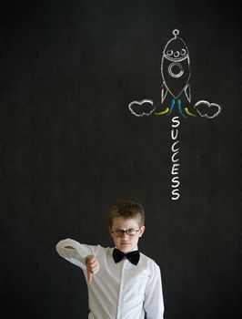 Thumbs down boy dressed up as business man with chalk success rocket on blackboard background