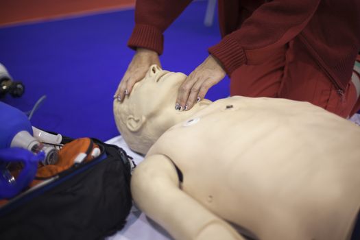 Paramedic demonstrates CPR on dummy