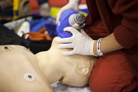 Paramedic demonstrates CPR on dummy