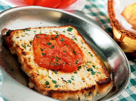 Saganaki - Feta cheese (fried) in olive oil with a slice of tomato on top.