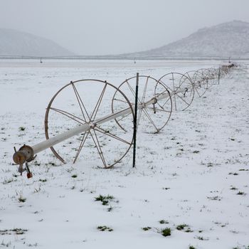 Cereal fields with irrigation wheels with snow in Nevada USA