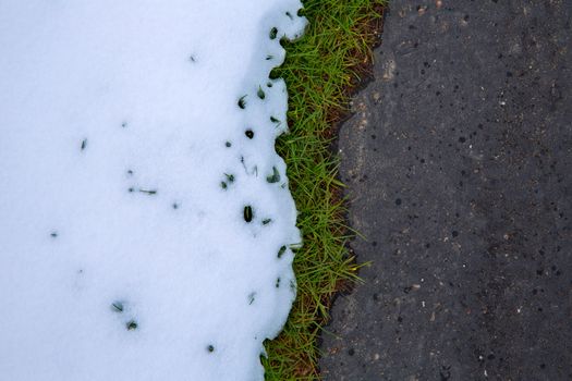 Snow in road with turf grass line texture detail