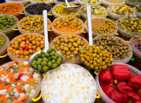 Pickles varied olives onion carrot lupins hot pepper gherkin in a row