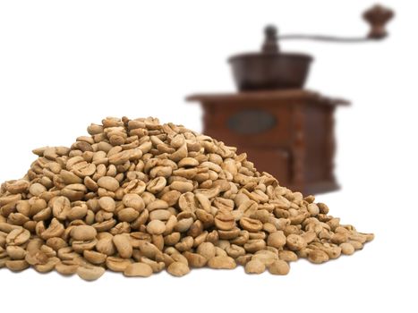 heap of coffe beans and coffe maker blurred in backside