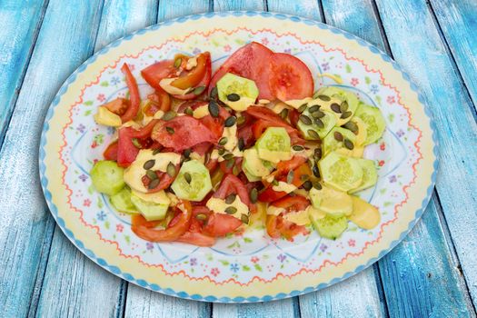 Mediterranean salad with tomato cucumber pumpkin seeds and sauce