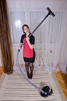portrait of attractive housewife with vacuum cleaner