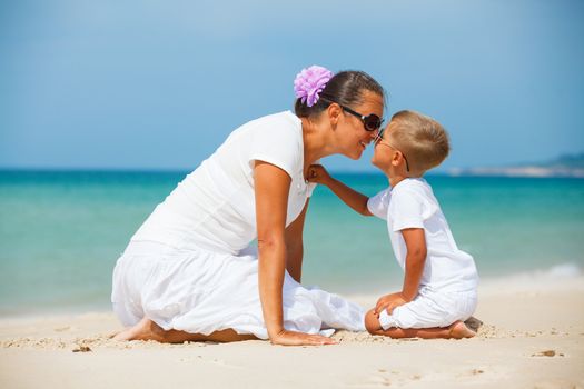 Mother and son having fun on tropical beach