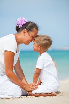 Mother and son having fun on tropical beach