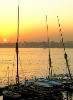 Felucca boats at the harbor at sunset, Luxor, Egypt