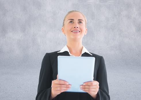 Composite image of blonde businesswoman holding tablet