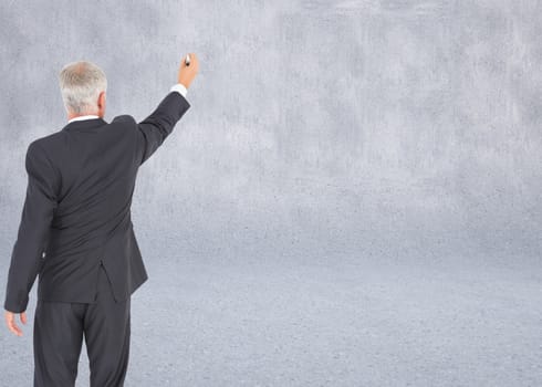 Composite image of rear view of serious businessman standing and writing