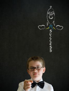 Education needs you thinking boy dressed up as business man with chalk success rocket on blackboard background