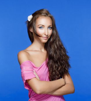 portrait of a beautiful young woman with brown hair - isolated on blue