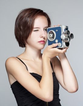teenage girl with an old film camera - isolated on gray