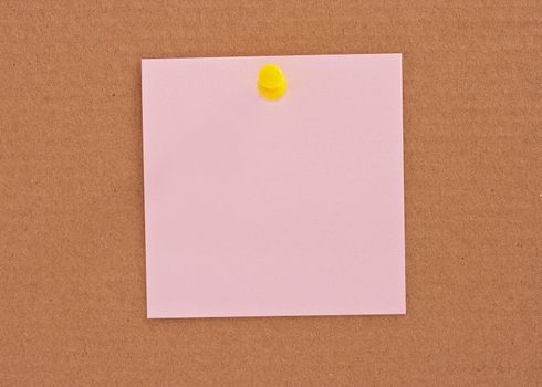 Pink note paper attached with yellow pin