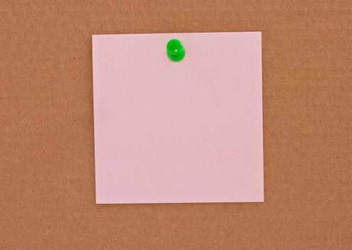 Pink note paper attached with green pin