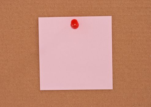 Pink note paper attached with red pin