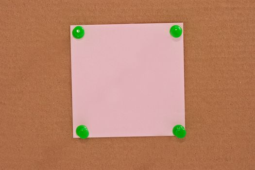 Pink note paper attached with green pin