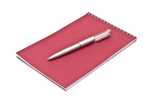Notebook with silver pen, isolated on white