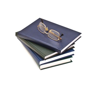 Stack of books and glasses, isolated on white background