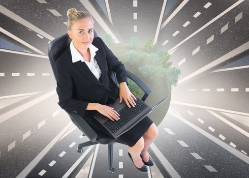 Composite image of blonde businesswoman sitting on swivel chair with laptop