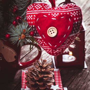Christmas decorations: heart, deer and sleds on old wooden table