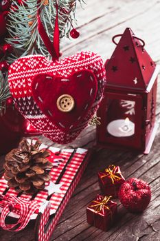 Christmas decorations: heart, candlestick and sleds on old wooden table